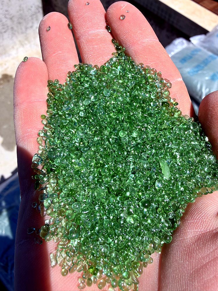 A handful of green glass beads ready for a pool interior
