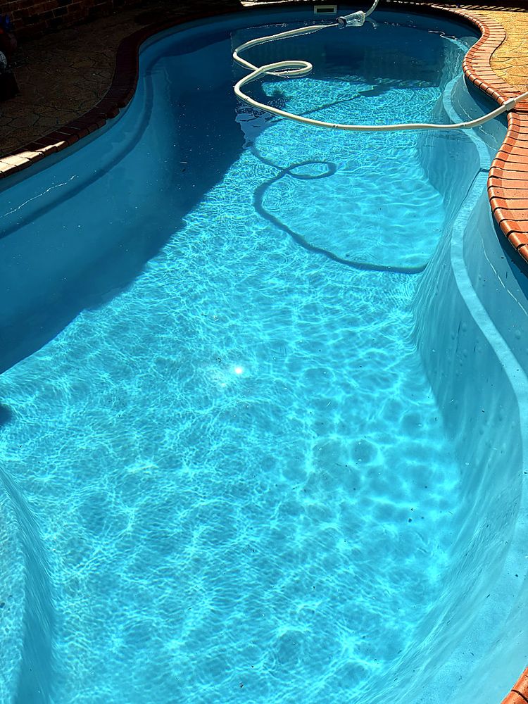 Curved pool with brick coping, sparkling water