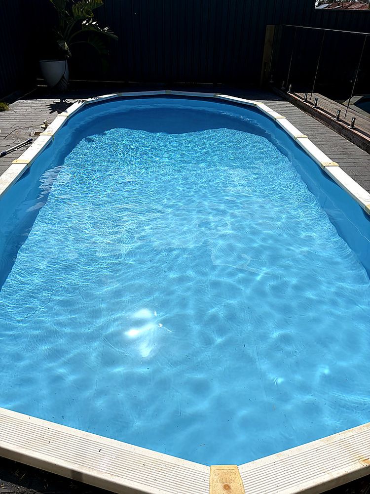 Oval pool with clear, sunlit water